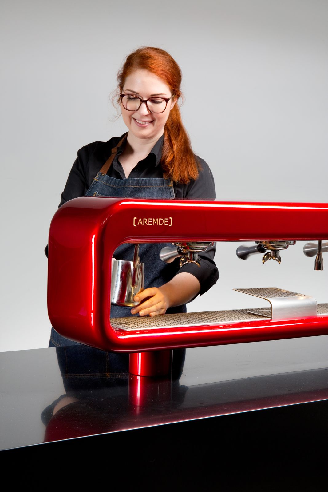 Barista working on an AREMDE machine