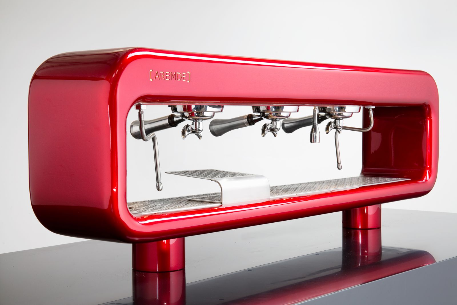 AREMDE machine in ruby red, angled view